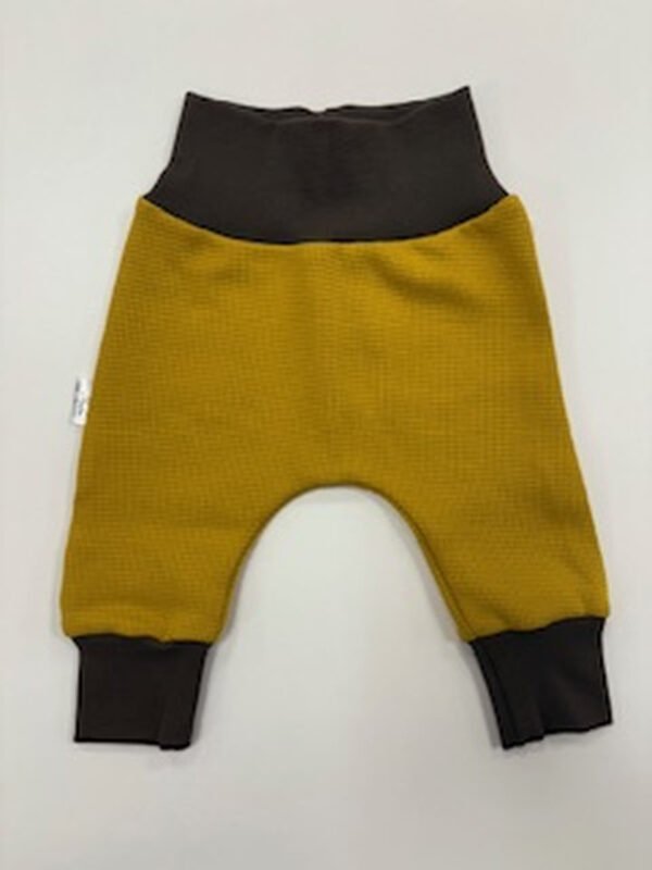 Žluté dětské tepláčky s tmavými manžetami