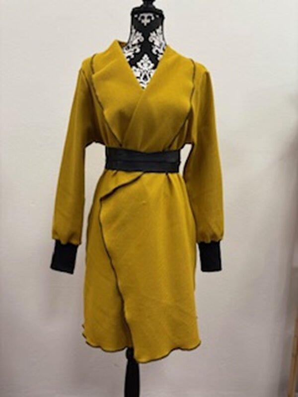 Žlutý kabát na figuríně s černým páskem.