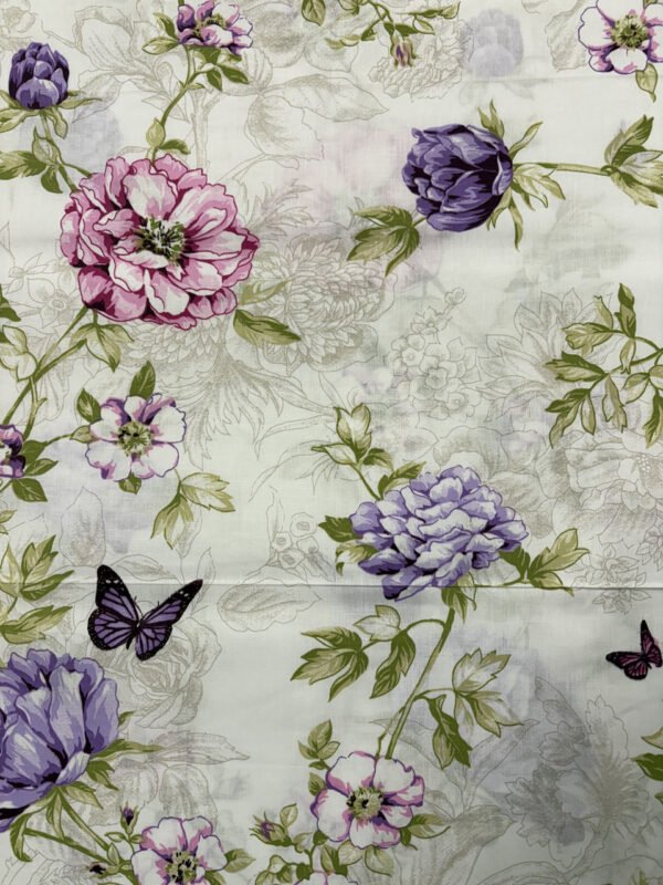 Květinový vzor s motýly na látce.