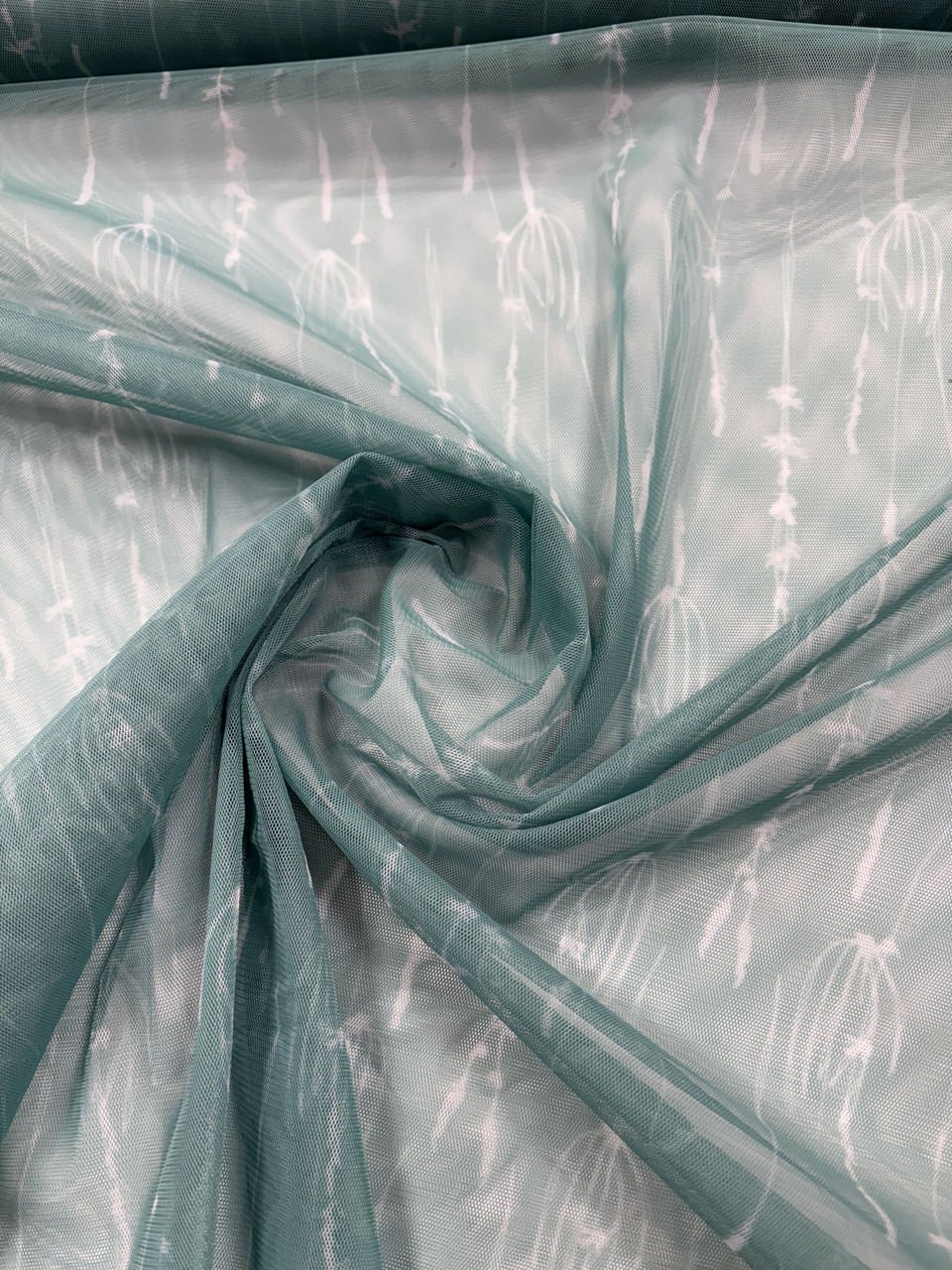 Zelená vzorovaná látka s abstraktním designem