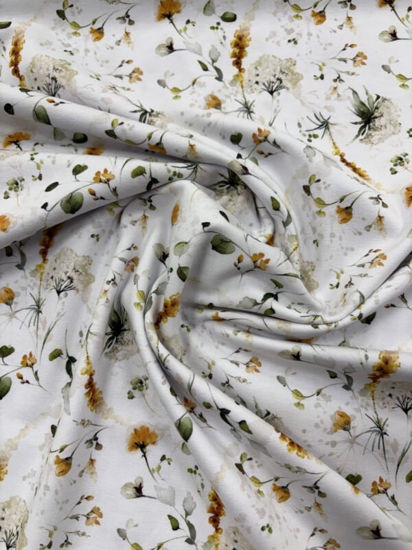 Bavlněná látka s květinovým vzorem v bílé barvě.