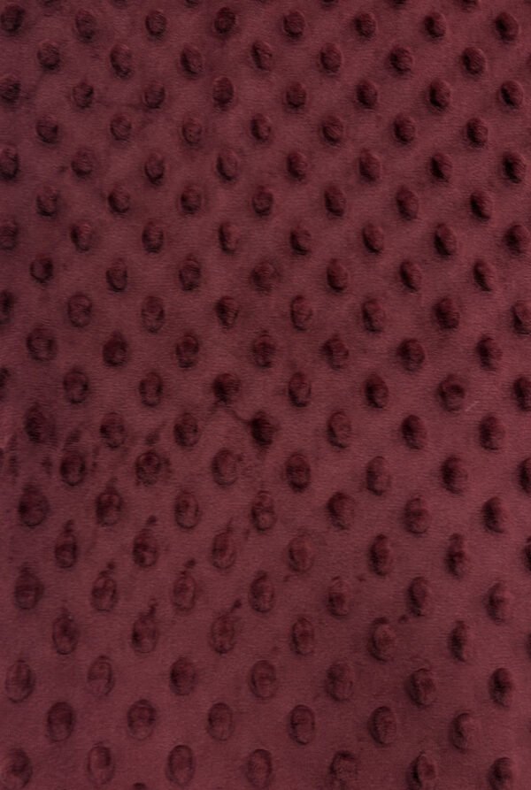 Hnědá textilní textura s vyvýšenými puntíky.