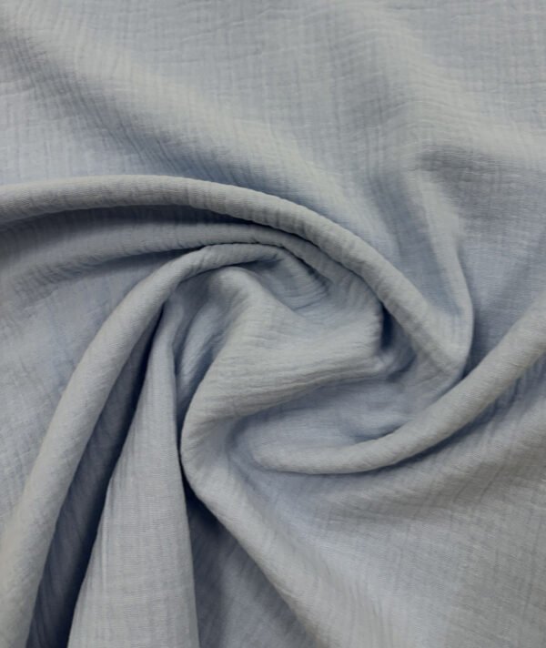 Světlá šedá látka s texturou, detail záběr.