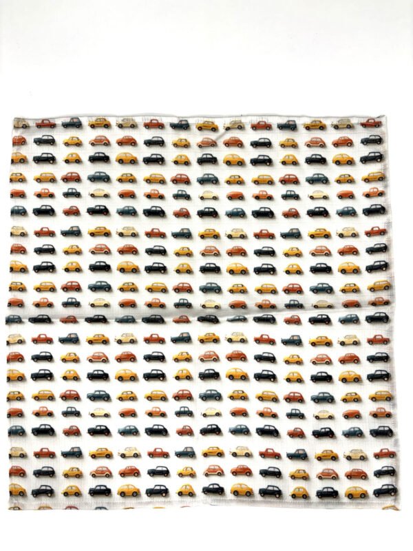 Vzorek látky s motivem aut v různých barvách.