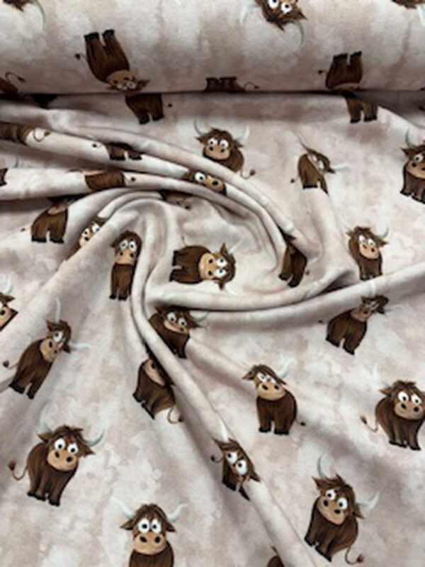 Látka s motivem roztomilých býků na béžovém pozadí.