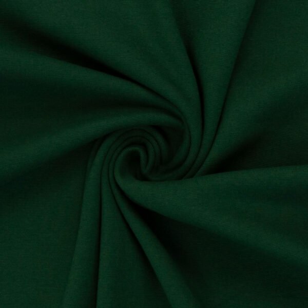 Zelená látka smotanově srolovaná do spirály.