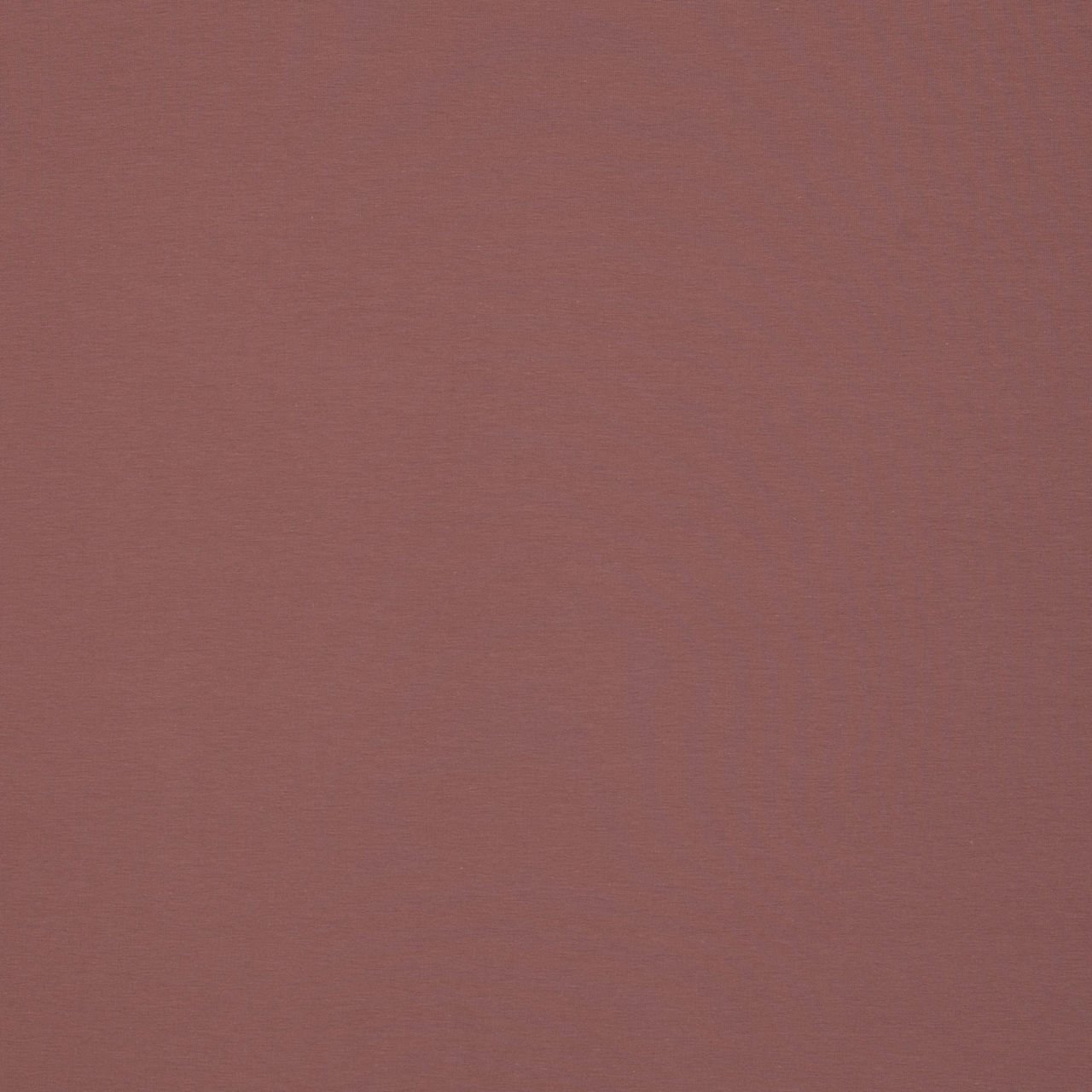 Jednobarevná červená textilie, detail struktury látky.